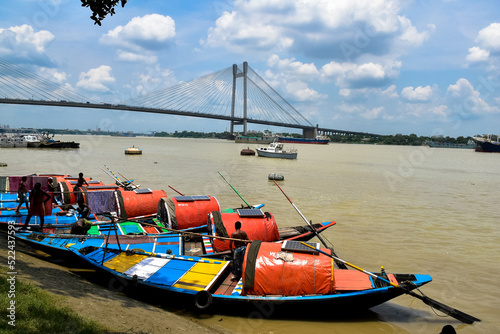 KOLKATA, INDIA - July 30, 2022: 2nd Hooghly Bridge (Vidyasagar Setu) on Hooghly River with view of boats seen from Princep Ghat at Kolkata. This is the first and longest cable stayed bridge in India