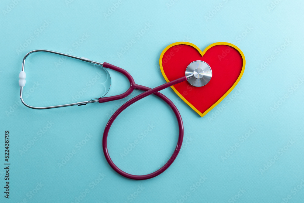 Red heart and stethoscope lies on a blue background Red heart and stethoscope lies on a blue background