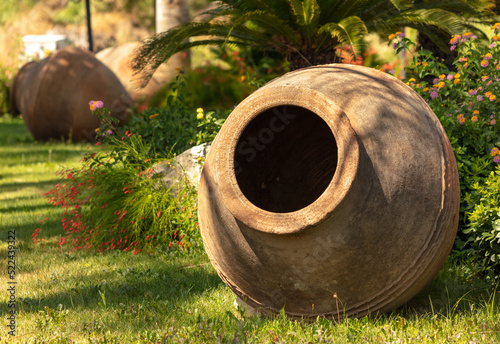 Large earthenware jugs on the green grass