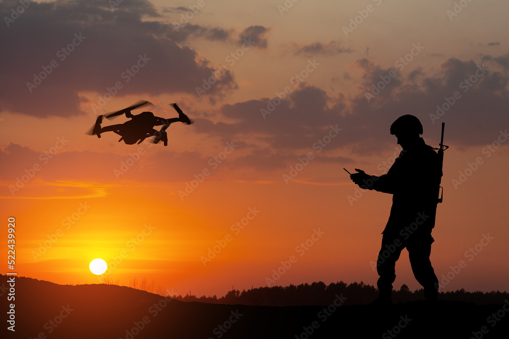Silhouettes of soldiers are using drone and laptop computer for scouting during military operation. Silhouettes of soldiers are using drone and laptop computer for scouting during military operation.