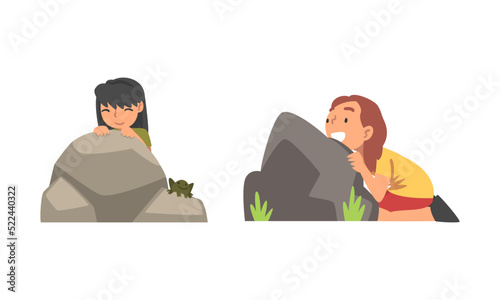 Fototapeta Naklejka Na Ścianę i Meble -  Kids playing hide and seek set. Cute girls hiding behind stones cartoon vector illustration
