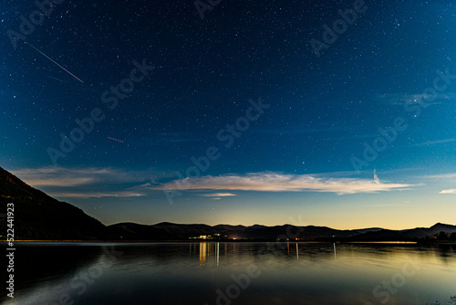 Bassenthwaite lake on a moonlit night with a meteor in the sky from the Perseids meteor shower
