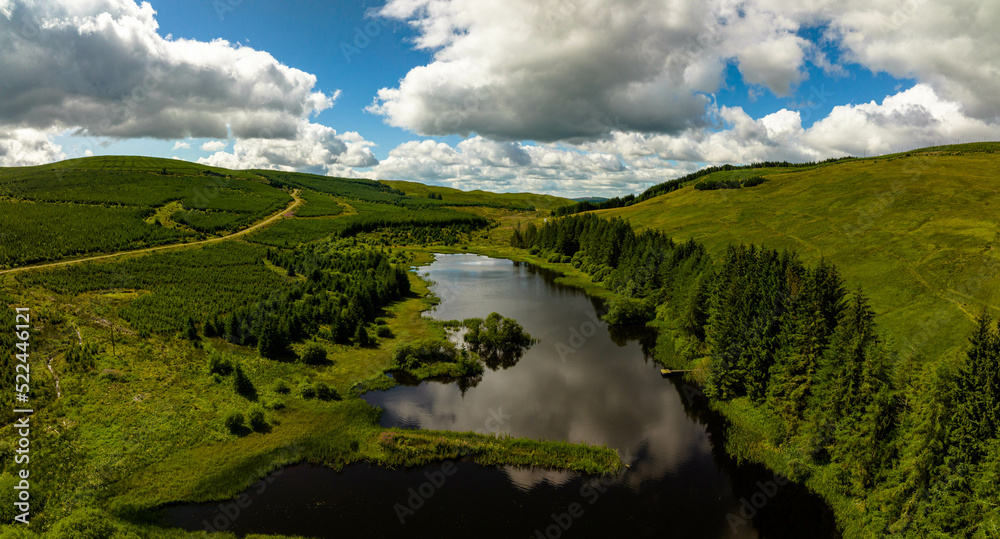 aerial view of the scottish borders countryside near moffat on a blue sky day with clouds during a day in the summer