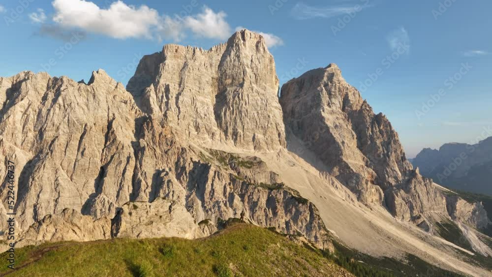 View from above, stunning aerial view of a person enjoying the view of Monte Pelmo from the summit of Col de la Puina. Monte Pelmo, Dolomites, Italy. View from above, stunning aerial view of a person enjoying the view of Monte Pelmo from the summit of Col de la Puina. Monte Pelmo, Dolomites, Italy.