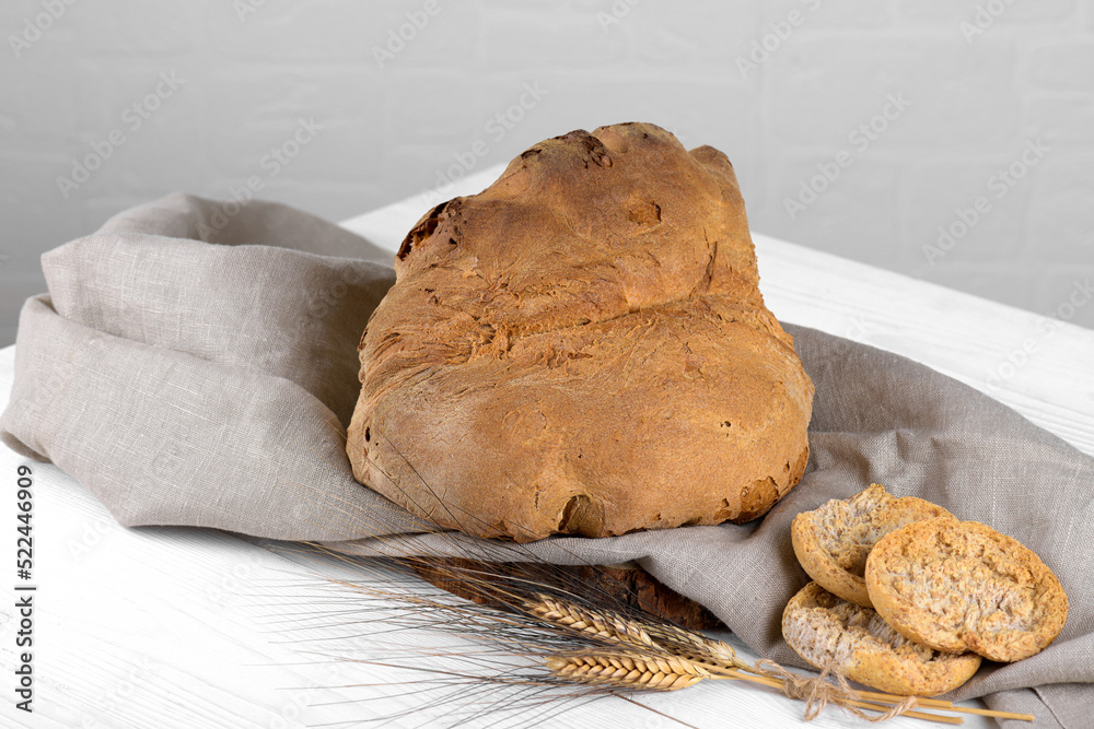 The bread of Matera, Pane di Matera on white wooden background, typical  southen italian sourdough bread,