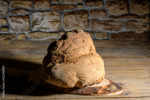 The bread of Matera, Pane di Matera on wooden background, typical southen italian sourdough bread, the crunchy loaf has the shape of a croissant and is produced with the use of durum wheat semolina photo