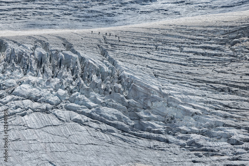 roped team of mountaineers on the ice of Steingletscher in the Bernese Alps photo