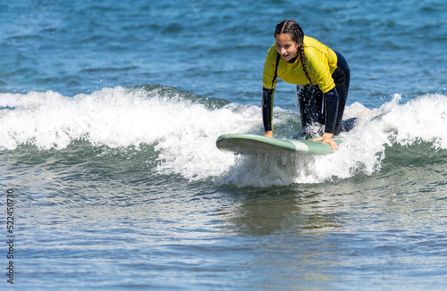 Woman kneeling on a surfboard