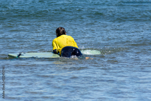 Woman relaxed on a surfboard in the sea