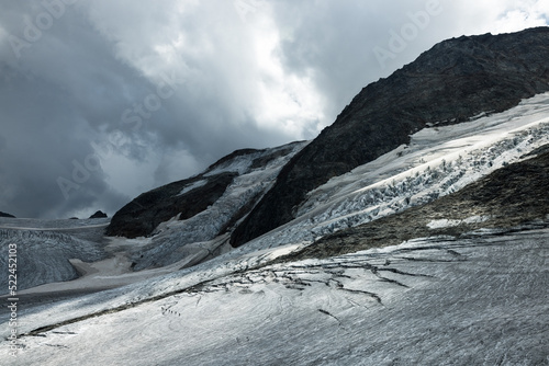 roped team of mountaineers on the ice of Steingletscher in the Bernese Alps photo