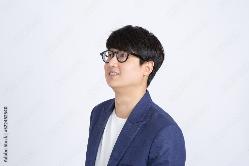 Positive handsome Asian business man smiling and looking up aside isolated white background Positive handsome Asian business man smiling and looking up aside isolated white background