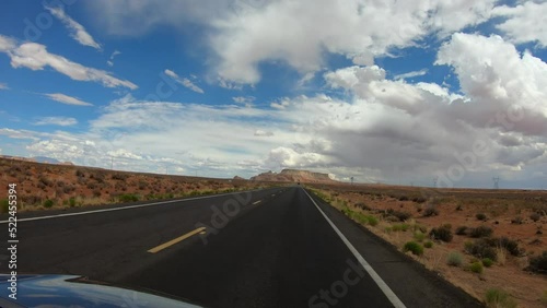 Page, Arizona, USA, June 23, 2022: TRAVELING CAR SLOW MOTION - Drive through Highway 98, from the northwest, with the LeChee Rock in the background.