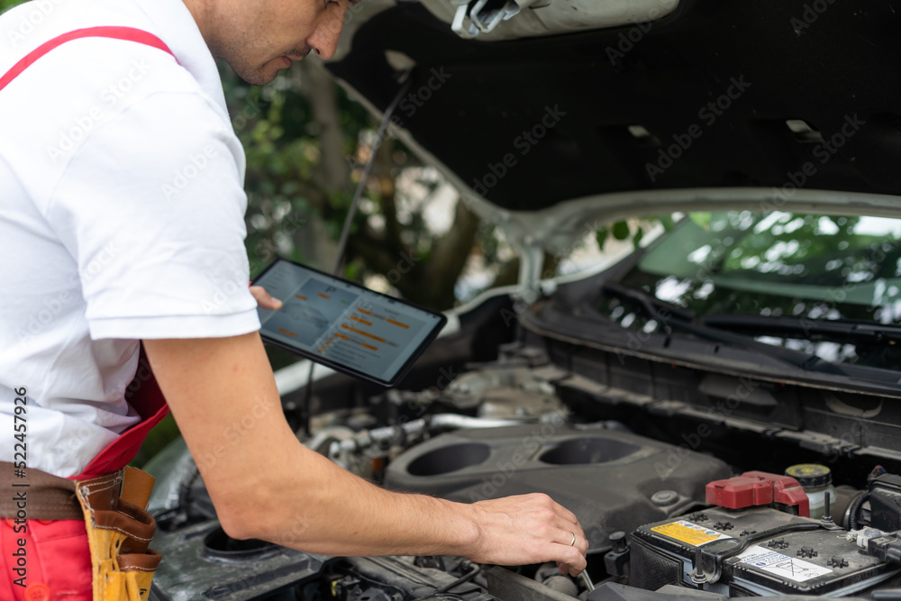 Close-up Of A Car Mechanic Using Digital Tablet Close-up Of A Car Mechanic Using Digital Tablet