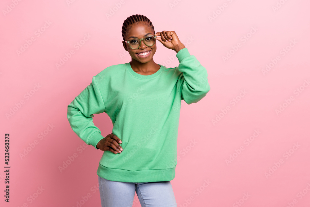 Photo of positive pretty lady arm touch sunglass beaming smile isolated on pink color background Photo of positive pretty lady arm touch sunglass beaming smile isolated on pink color background
