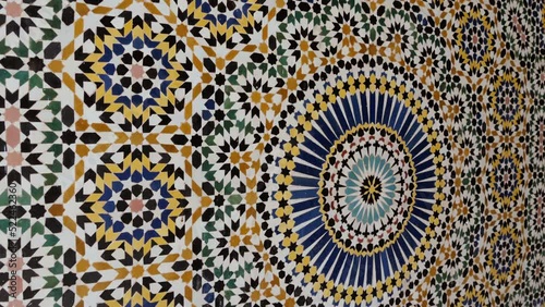 Moroccan zellige mosaic pattern in traditional Islamic geometric design in Morocco. Made with natural colors from indigo, saffron, mint, kohl. 4k Moroccan design background footage.  photo