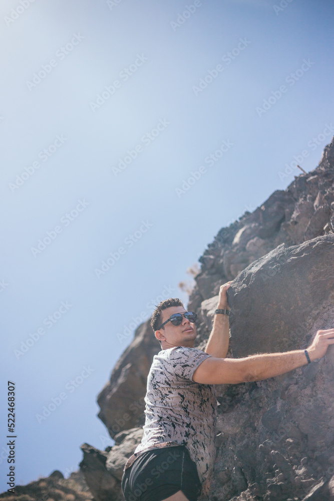 Obraz premium handsome young Latin climbing volcanic mountain