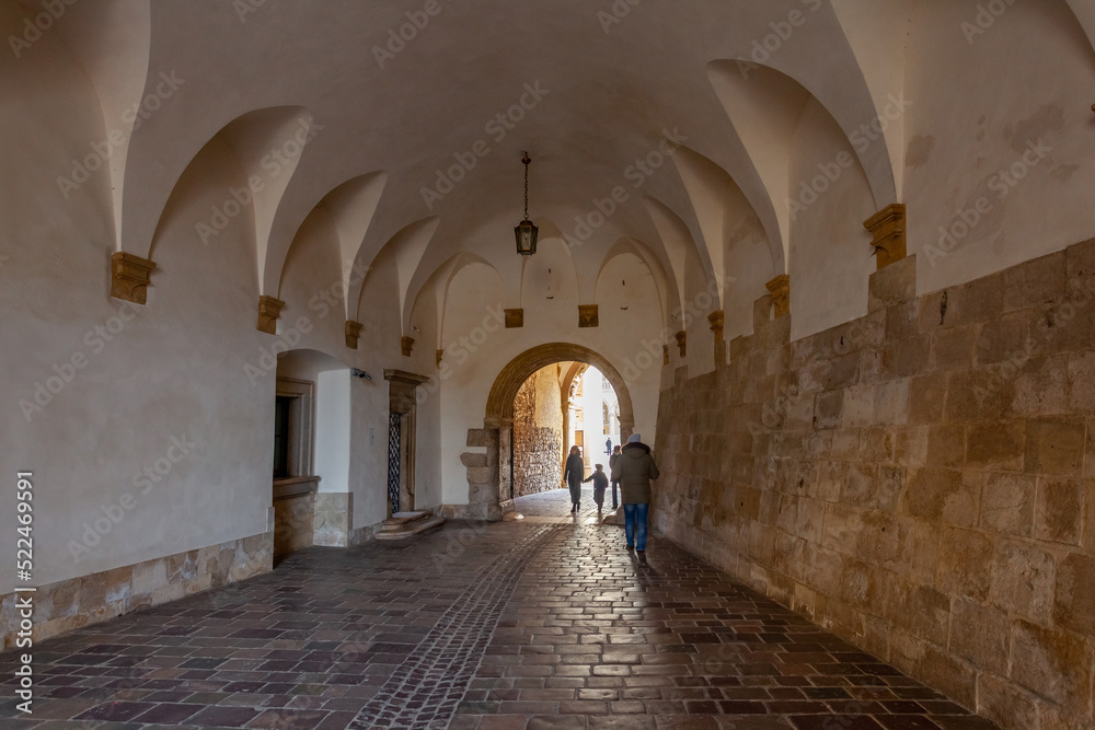 The picture shows the entrance to the courtyard of an ancient castle called Wawel in Krakow, Poland