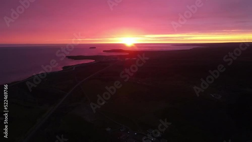 Stunning aerial shot of an orange sunset in Iceland. Amazing colors with the mountains and the reflection of the sky on the river. photo