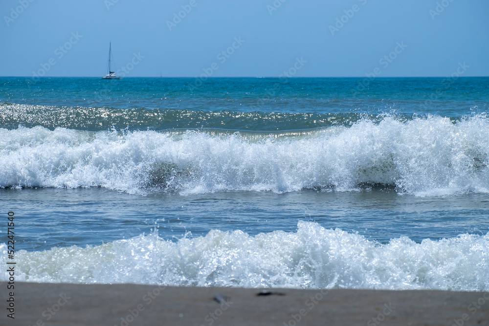 Fototapeta premium Ocean waves crashing on sandy beach. Sea waves breaking on Maditerranean's shore.