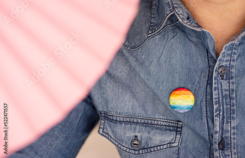 man with rainbow pin lgtbiq collective symbol, close up 