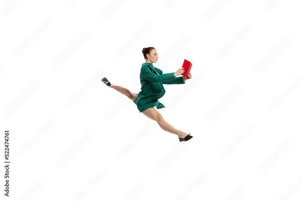 Leap. Stylish young woman in business style outfit in motion isolated over white background. Emotions, finance, aspiration, business, job concept.