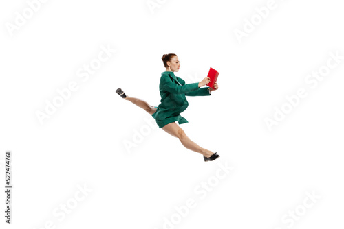 Leap. Stylish young woman in business style outfit in motion isolated over white background. Emotions, finance, aspiration, business, job concept.