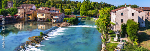 Borghetto sul Mincio - one of the most beautiful medieval villages of Italy. colorful houses located in the middle river and waterfalls. Verona province, near Garda Lake photo