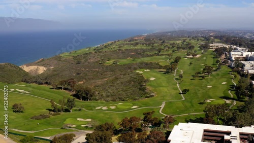 Aerial Shot Of Torrey Pines Golf Course On Cliff By Sea, Drone Flying Backwards During Sunny Day -  San Diego, California photo
