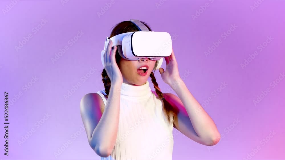 Metaverse concept, amazed young asian woman wearing white vr headset touching on the purple neon screen background. 4K video asian girl futuristic style gamer. Metaverse concept, amazed young asian woman wearing white vr headset touching on the purple neon screen background. 4K video asian girl futuristic style gamer.