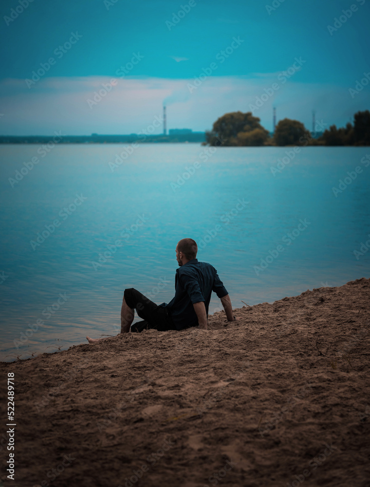 Fototapeta premium a series of photographs of a man barefoot near the water in the evening