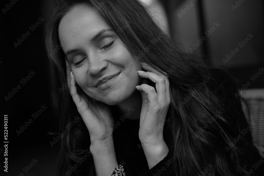 Sensual portrait of a young brunette in a white dress. Girl in a autumn wear is sitting in a chair 