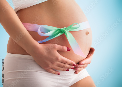 Wallpaper Mural Pregnant belly with colored ribbon. Third trimester. Torontodigital.ca