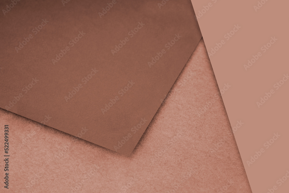 Fototapeta premium Plain and Textured pastel brown papers randomly laying to form M like pattern and triangle for creative cover design idea