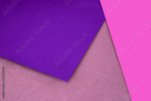 Plain and Textured pink peach purple papers randomly laying to form M like pattern and triangle for creative cover design idea