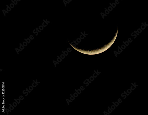 crescent moon against black night sky background