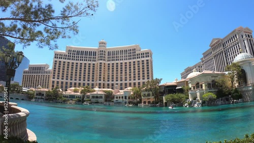 Las Vegas, Nevada, USA, June 25, 2022: TILT SHOT - The Bellagio Hotel and Casino and Caesars Palace Hotel and Casino and Fountains of Bellagio in Las Vegas, NV. photo