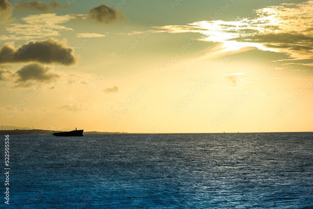 Sunset on the sea of Fortaleza with silhouette of a shipwreck