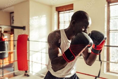Young boxer training in a gym