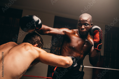 Billede på lærred Two male fighters having a match in a boxing ring
