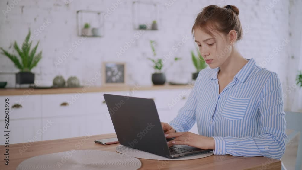 finish project turn of laptop pleased woman with beautiful freckles sitting at the table in living room with white modern interior finish project turn of laptop pleased woman with beautiful freckles sitting at the table in living room with white modern interior
