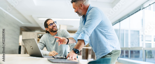 Successful businessmen working together in a co-working office