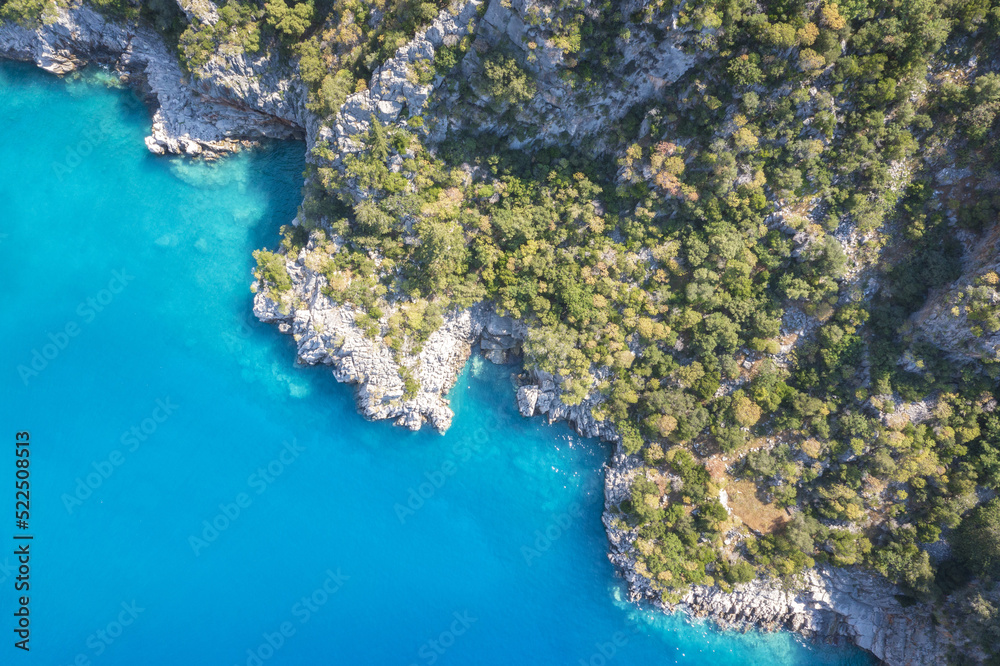 Beautiful aerial view of sea lagoon with blue water, Mediterranean, Turkey.  Small rocky island among sea.  The bottom of the sea from above.