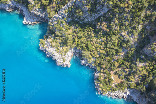 Beautiful aerial view of sea lagoon with blue water, Mediterranean, Turkey. Small rocky island among sea. The bottom of the sea from above.