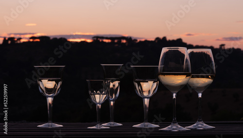 Elegant wine glasses at sunset