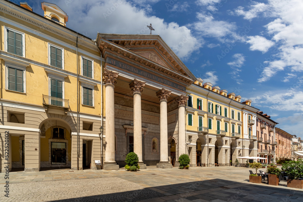 Cuneo, Piedmont Italy - August 6, 2022: the Cathedral of St Mary of the Woods , the facade by Antonio Bono with 4 Corinthian columns,  portico and tympanum and historic buildings in Via Roma