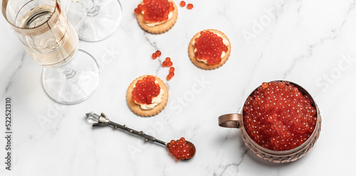 Delicious snacks with cream cheese and red caviar with glass of champagne, Festive drink. Valentins or Christmas concept