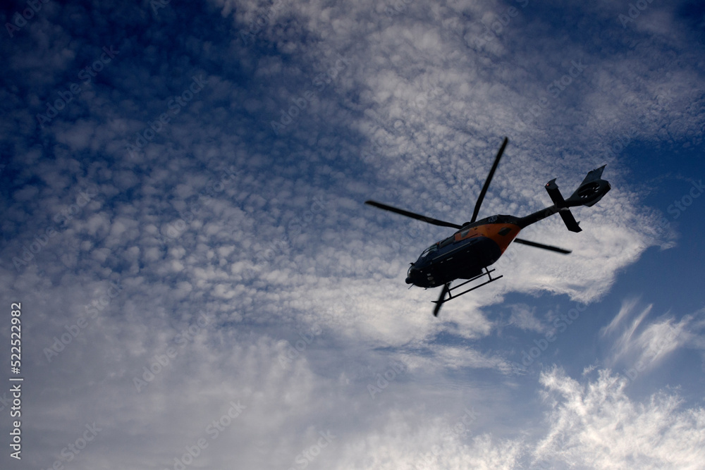 silhouette of helicopter flying in the sky silhouette of helicopter flying in the sky