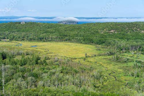 Meadow, islands covered by clouds in Acadia National Park