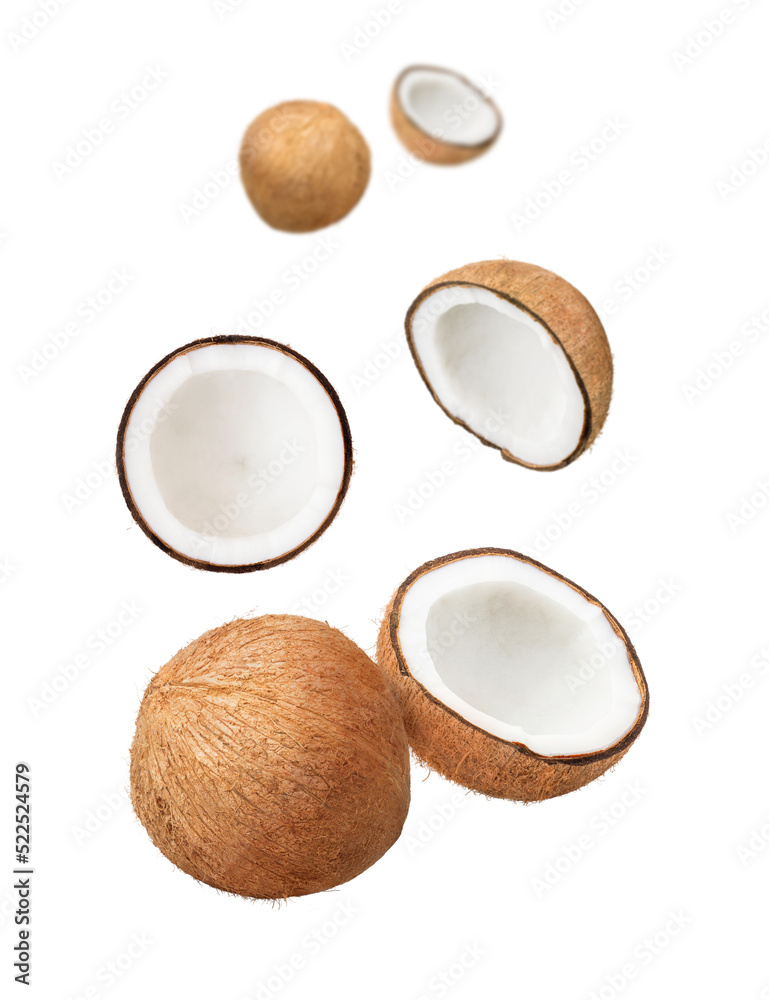 Coconut with cut slices flying in the air isolated on white background. Coconut with cut slices flying in the air isolated on white background.