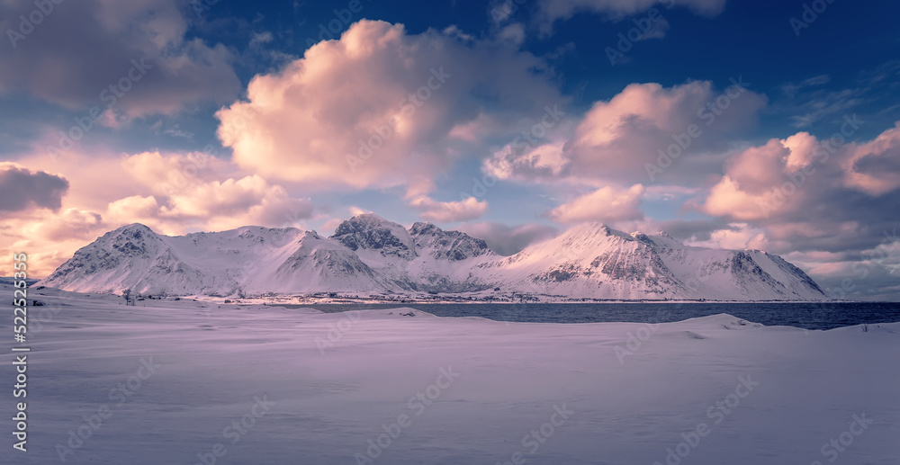 Snowcapped mountains, glacier lagoon, blue perfect sky with clouds. Wonderful winter landscape of frosty, sunny day. Stunning view of winter nature. Wonderful Wintry Landscape. Scenic image of Norway